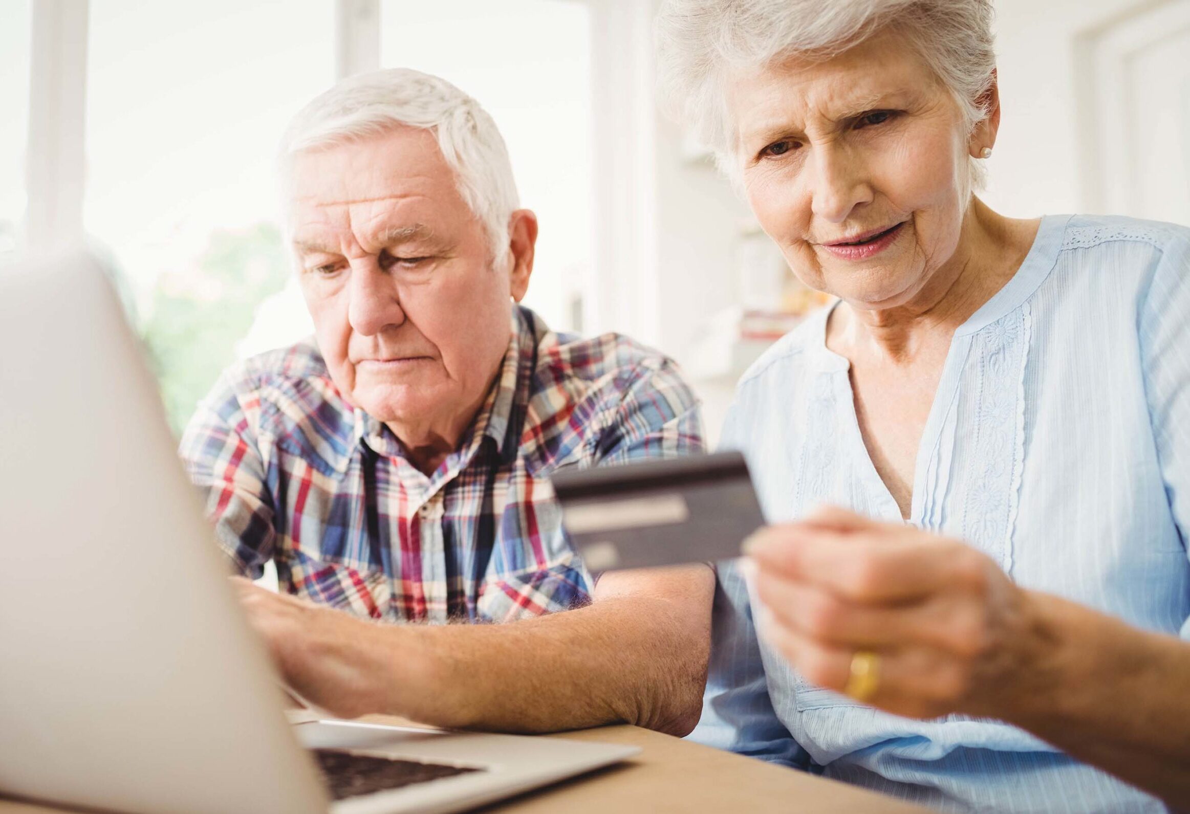 elderly couple ordering on the computer