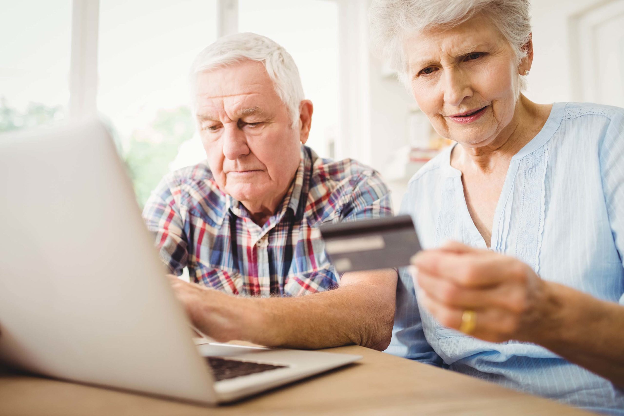 elderly couple ordering on the computer