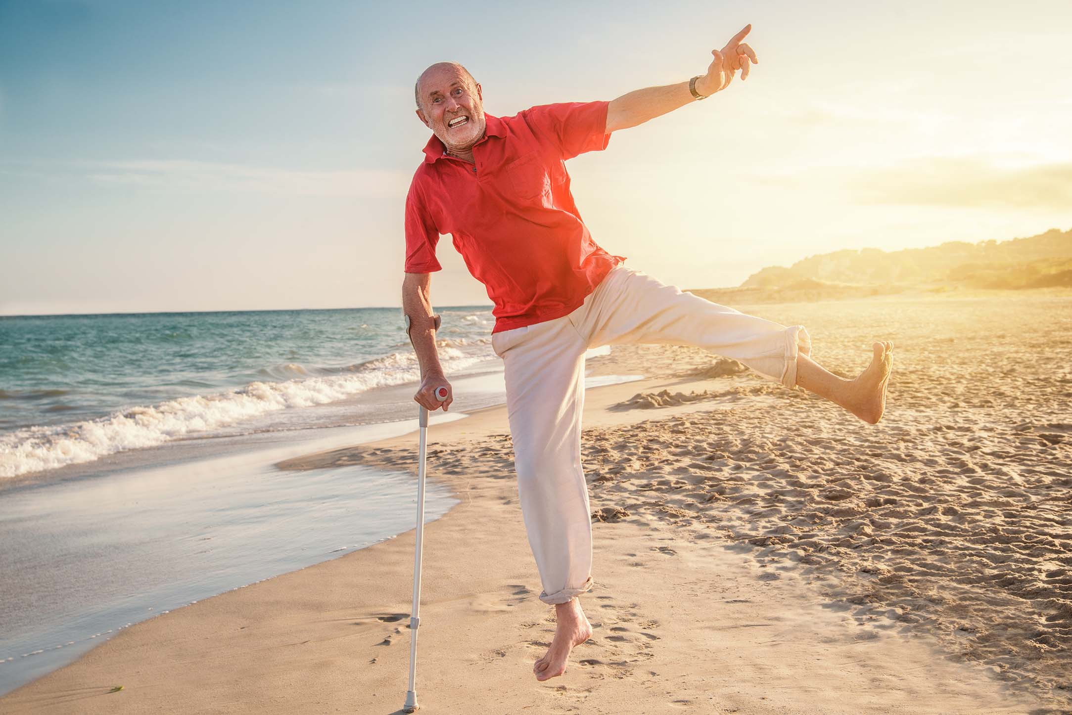 elderly man at the beach with cane